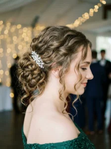 Soft curly updo with loose tendrils elegant prom hairstyle