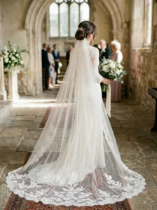 Low bridal bun paired with a wedding veil