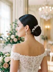 Classic bridal chignon hairstyle with pearl accessories