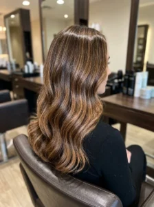 Glossy caramel highlights on brown hair