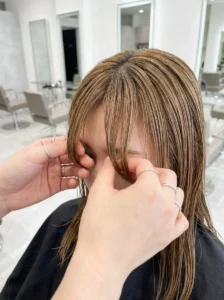 Styling curtain bangs with a round brush