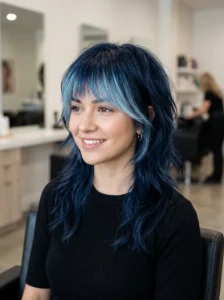 Wolf cut hairstyle with blue ombre bangs.