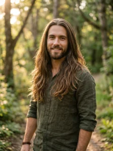Man with long layered hair and a center part creating natural flow