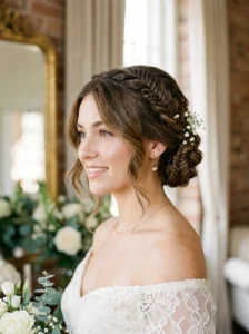 Formal braided updo with loose wolf cut face-framing layers.