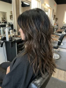 Black wolf cut with subtle dark-brown balayage on long layers
