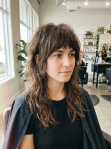 Full textured bangs with a choppy layered wolf cut