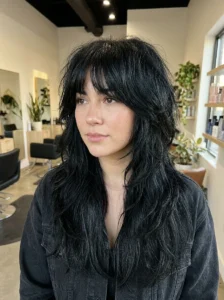Jet black wolf cut with dramatic layers on long hair