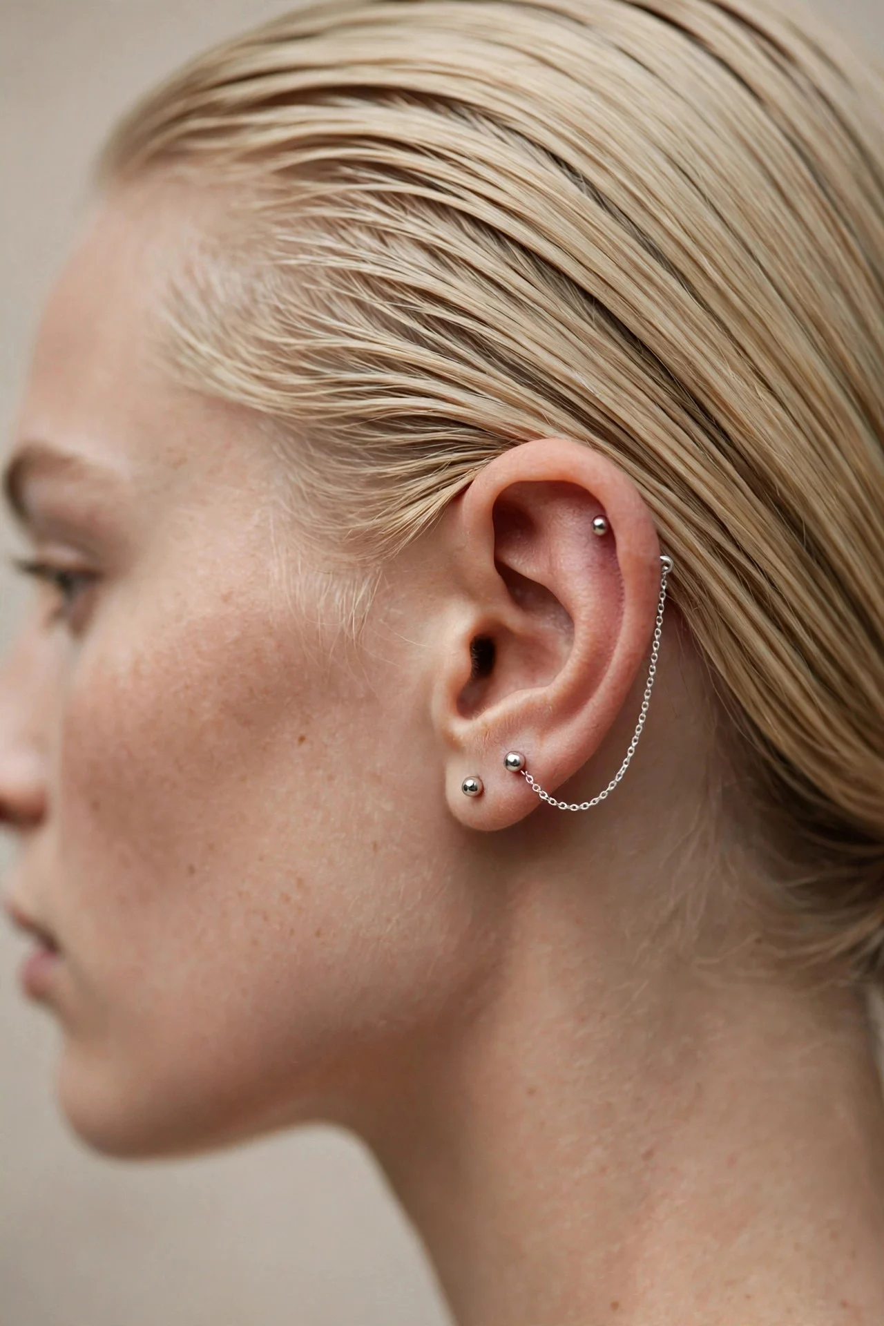 Chain Draped Between Double Piercings hair